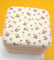 Floral-patterned fabric box on a yellow background