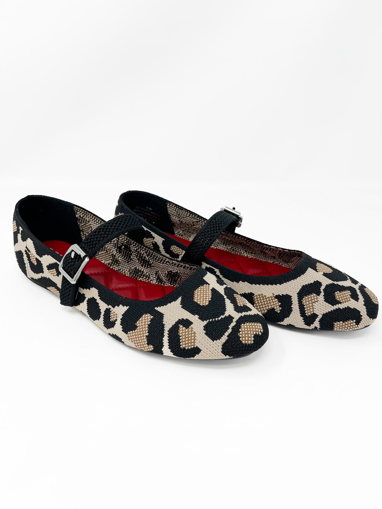 Leopard print ballet flats with a buckle on a white background