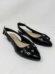 Pair of black slingback shoes on a light gray background