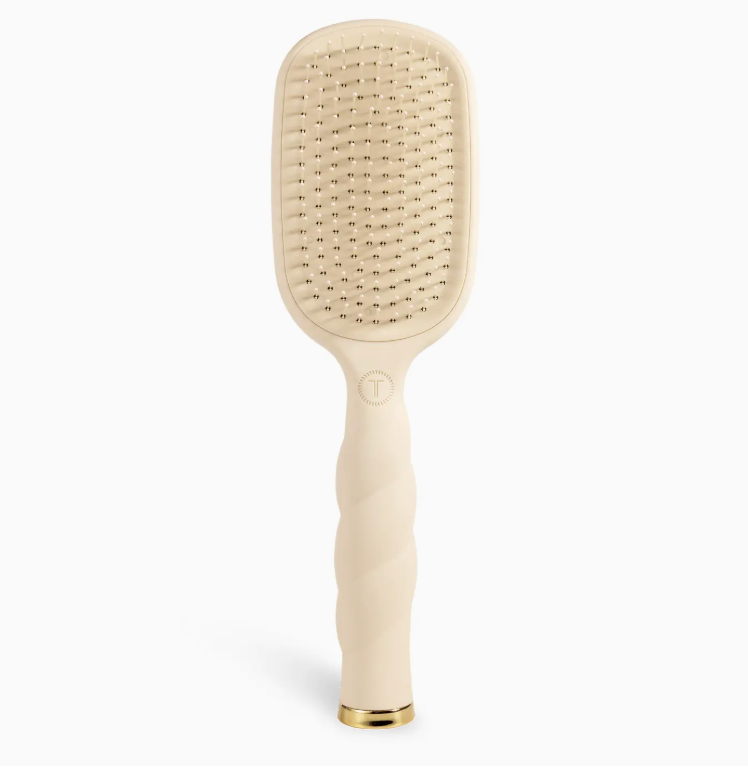 Beige paddle hairbrush on a white background