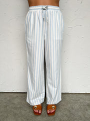 Striped pants worn by a person on a plain background