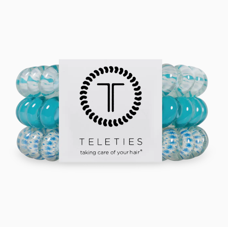 Turquoise hair ties with a Teleties branded card on a white background