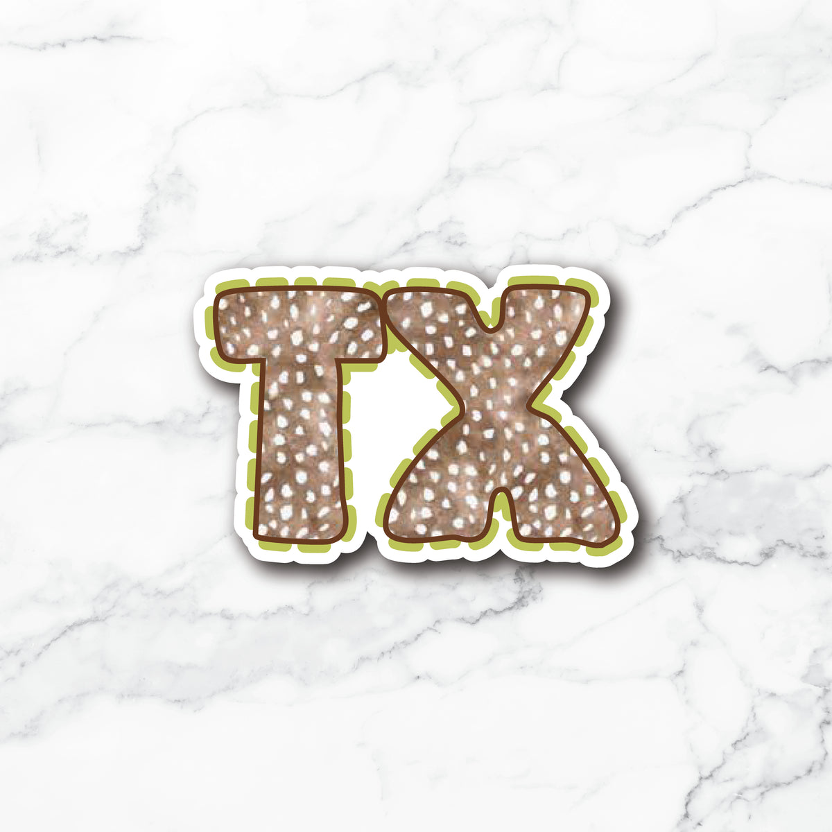 A die-cut vinyl sticker featuring the letters 'TX' in a brown and white speckled deer-print pattern, outlined in olive green and white, displayed on a white marble background.