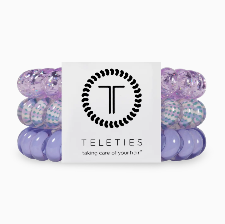 Three purple hair ties with a Teleties label on a white background