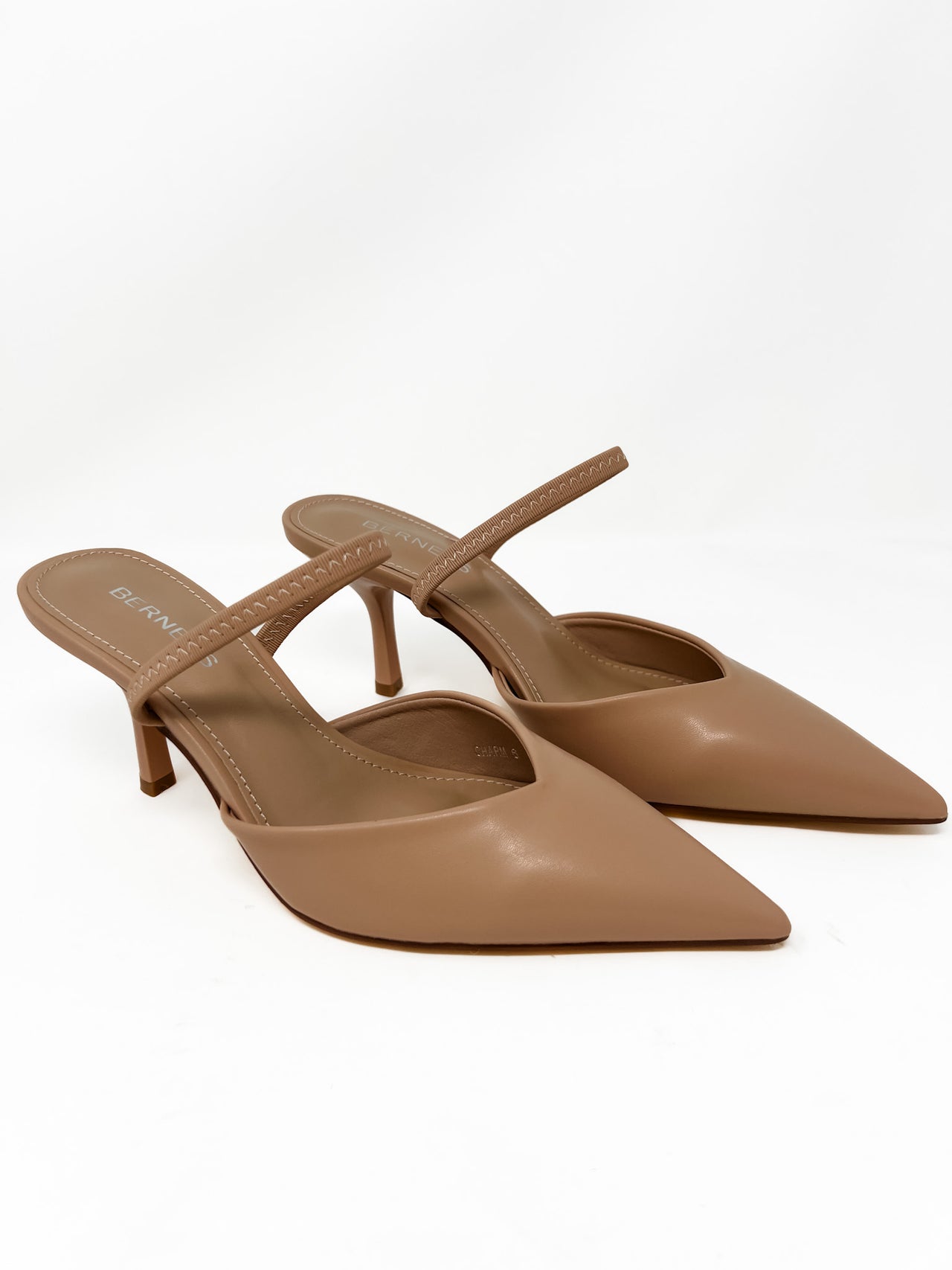Pair of tan high-heeled thin strap on a white background