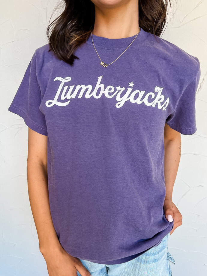 Person wearing a purple t-shirt with 'Lumberjacks' text against a white background