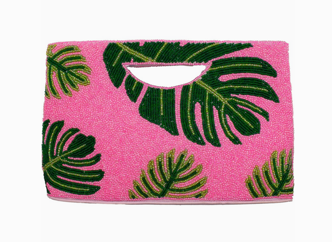 Pink beaded clutch with green leaf pattern on a white background