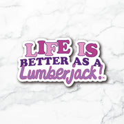 A die-cut vinyl sticker with the text 'LIFE IS BETTER AS A Lumberjack!' in pink and purple lettering with a white border, displayed on a white marble background.