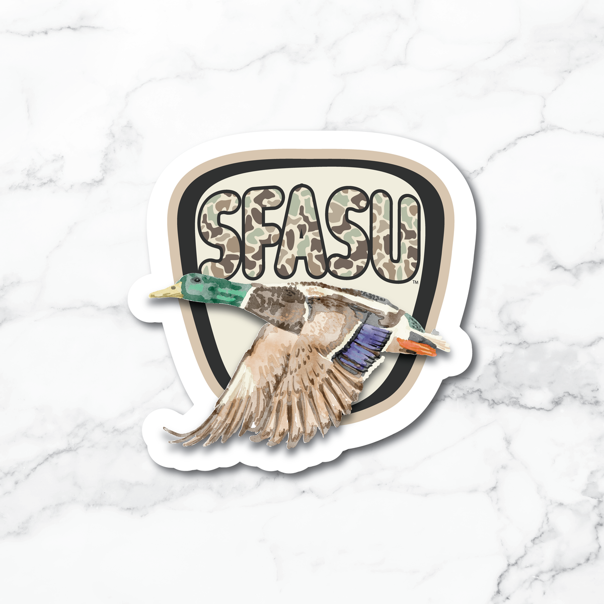A die-cut sticker featuring a flying mallard duck in front of a shield with the text 'SFASU' in camouflage lettering, shown on a white marble background.