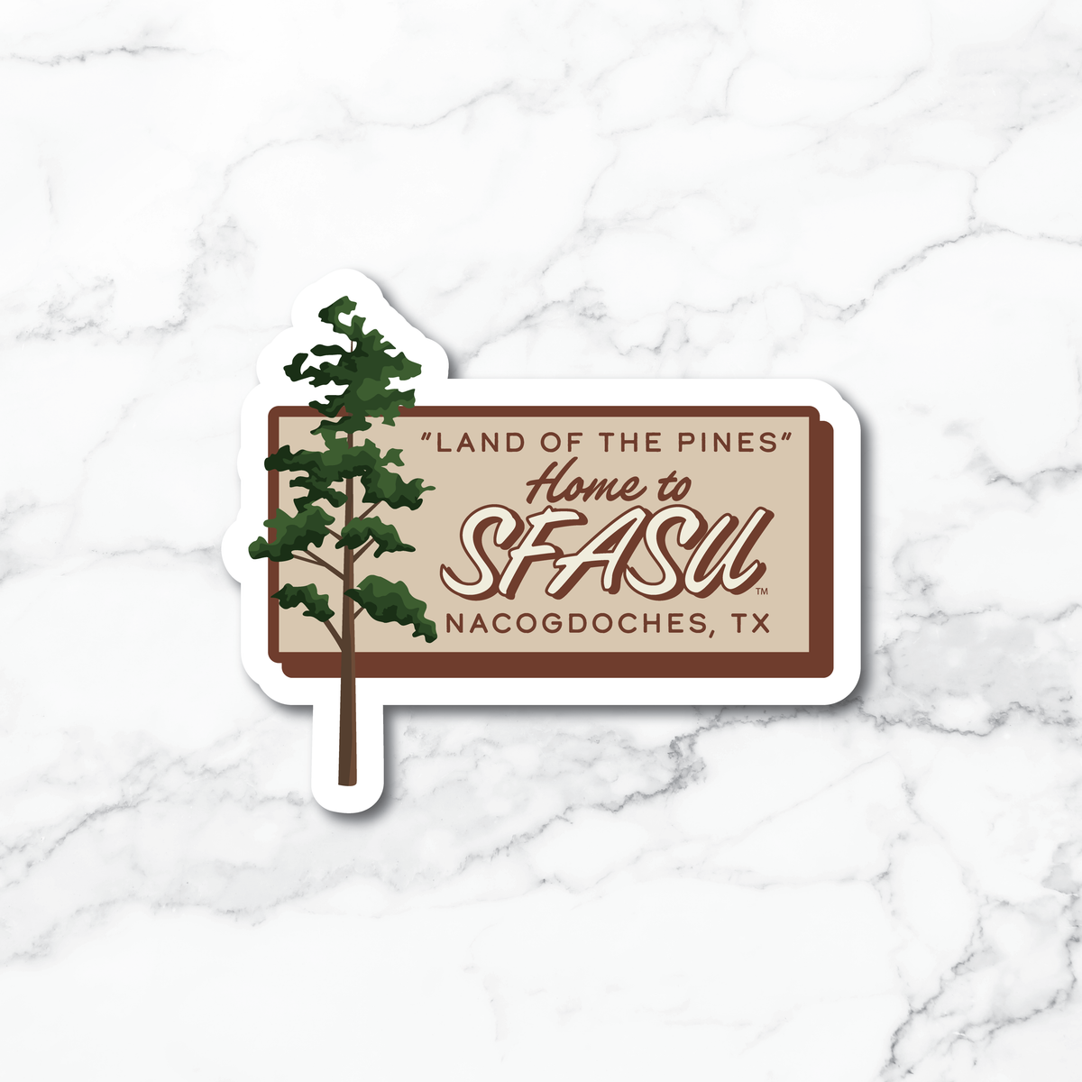 A die-cut sticker featuring a pine tree and the text “Land of the Pines Home to SFASU. Nacogdoches, TX” on a white marble background.