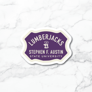 A die-cut sticker featuring the Stephen F. Austin State University Lumberjacks logo, displayed on a white marble background.